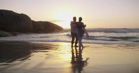 Happy couple, dancing on beach and playful in sunset and married on holiday, outdoor and retired. Retirement, elderly or love for commitment, bonding together or care for romantic relationship - Powered by Adobe