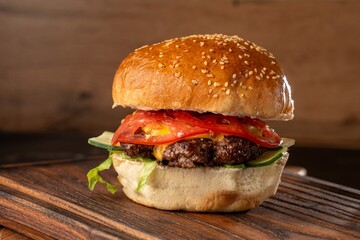 Burger on a wooden board with drink