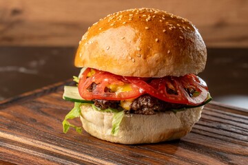 Burger on a wooden board with drink