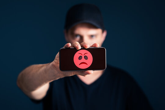 Angry customer and client complaining. Bad service complaint with phone. Mean online hate comment on social media by cyber bully or internet troll. Negative feedback or rating. Mad rage face icon.