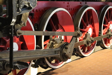 Wheels of an ancient steam locomotive train close-up. Railway rails.