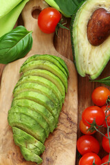 fresh organic avocado sliced on a board