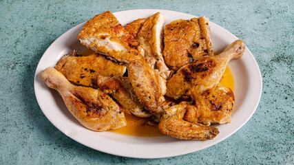 Roasted chicken pieces on plate