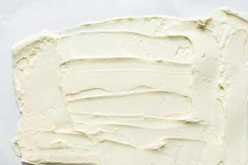 Top view of buttercream for decorating cake, silky smooth american buttercream on a marble surface, overhead view of smooth buttercream