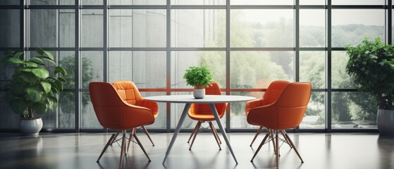Orange leather chairs at round meeting table against cement wall and glass windows
