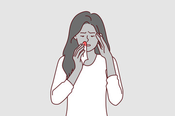 Bleeding from nose of sick woman holding handkerchief with blood stains, caused by high intracranial pressure. Upset girl in casual t-shirt needs medications to lower intracranial pressure