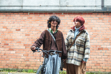 Fototapeta na wymiar Young couple holding bikes looking at each other