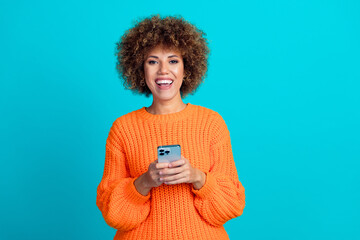 Photo of cheerful positive glad girl wear orange stylish clothes hold modern gadget 5g connection...