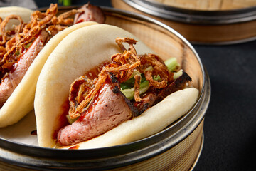 Gourmet Bao buns with roast beef and crispy fried onions; a modern twist on a classic Asian dish