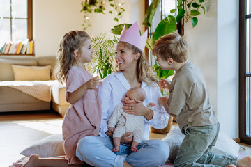 Mother after giving birth as a queen. Daughter giving mom a paper crown, admiration, love for...