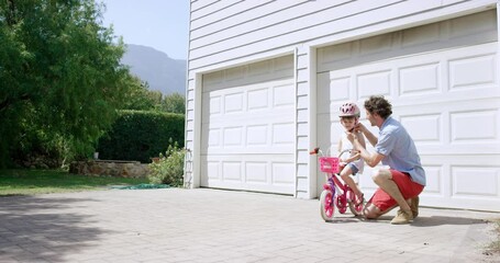 Bicycle, helmet and father teaching child in outdoor driveway at modern family home for bonding. Love, care and dad helping girl kid with head gear for learning to cycle on bike outside house.
