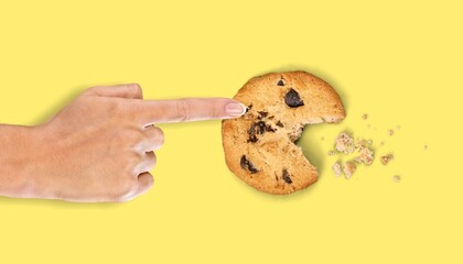 Hand holding tasty sweet cookie with chocolate