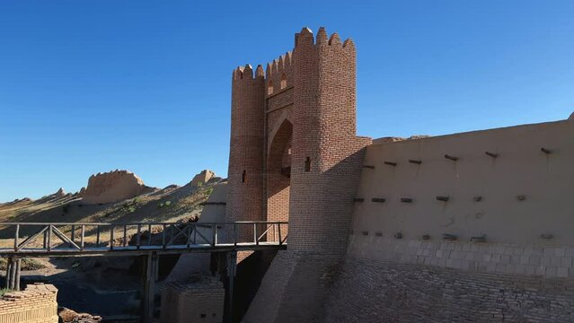 Turkestan walls of the ancient city of Sauran on a sunny day with a blue sky. Ancient buildings, fortress, ruins, ancient architecture in the settlement of Sauran. Archaeological excavations.