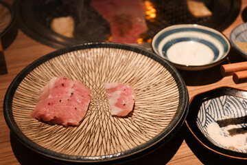 two pieces of raw wagyu beef on a plate ready for grilled barbecued