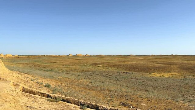 Turkestan walls of the ancient city of Sauran on a sunny day with a blue sky. Ancient buildings, fortress, ruins, ancient architecture in the settlement of Sauran. Archaeological excavations.