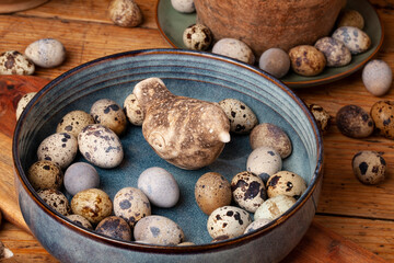 A vibrant display of natural quail eggs, resting on a rustic wooden surface.
