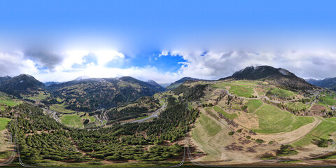 360 degree panorama. Highway between the mountains with the green fields in the region Albula Alvra at the Springtime. Switzerland Alps.