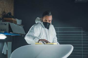 Shaper working on surf board