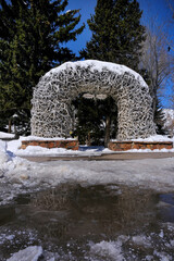 Antler Arch in Jackson Hole Wyoming Landmark Reflection in Melting Snow Water