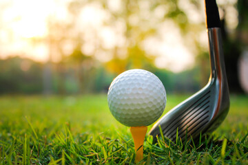 Grass field with golf balls placed on a yellow tee.