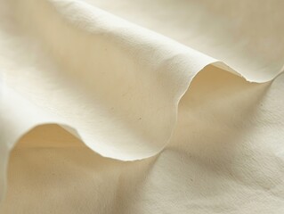 Softly textured paper in a light beige color evoking warmth and simplicity