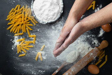Flour and men hands with flour splash. Cooking bread, pasta. Kneading the Dough. Top view