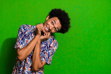 Closeup photo of young cute funny handsome positive man touching cheeks appreciate his birthday gift isolated on green color background