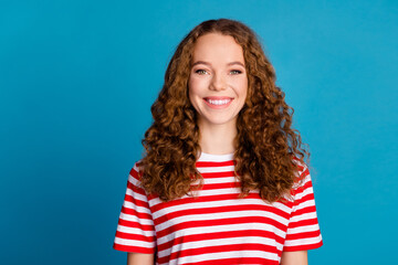 Photo of good mood adorable woman with wavy hairstyle dressed striped t-shirt toothy smiling at camera isolated on blue color background - obrazy, fototapety, plakaty