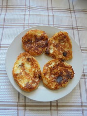 pancakes with cheese on a white plate