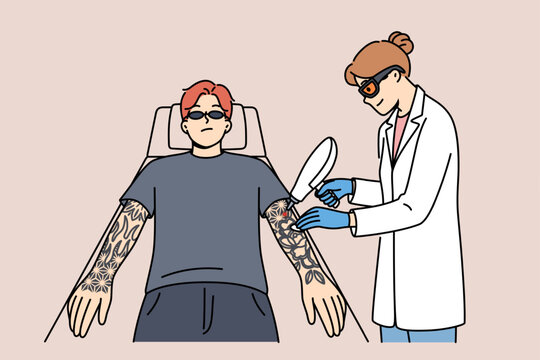 Procedure for laser tattoo removal from guy arms, with professional woman doctor. Casual man wants to get rid of tattoos made at young age and interfering with professional growth.