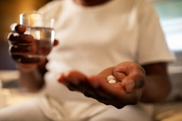 Senior man taking medication in bedroom