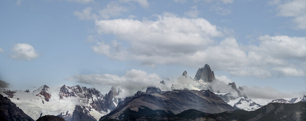 Majestic Mountain Peaks Covered by Snow and Clouds