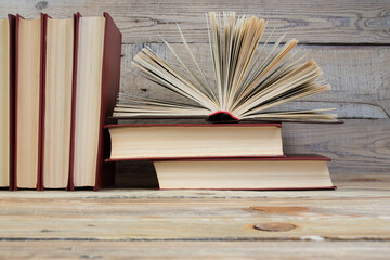 Open book, hardback books on wooden table. wooden background. Back to school. Education. Copy space for text.