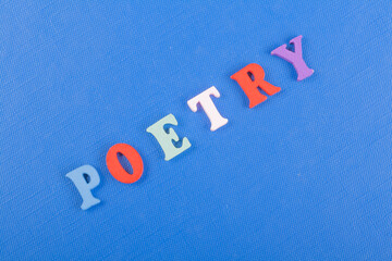 POETRY word on blue background composed from colorful abc alphabet block wooden letters, copy space for ad text. Learning english concept.