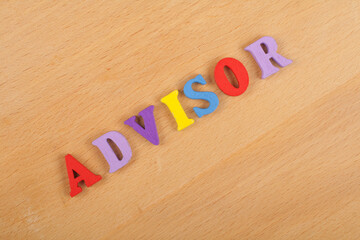 ADVISOR word on wooden background composed from colorful abc alphabet block wooden letters, copy space for ad text. Learning english concept.