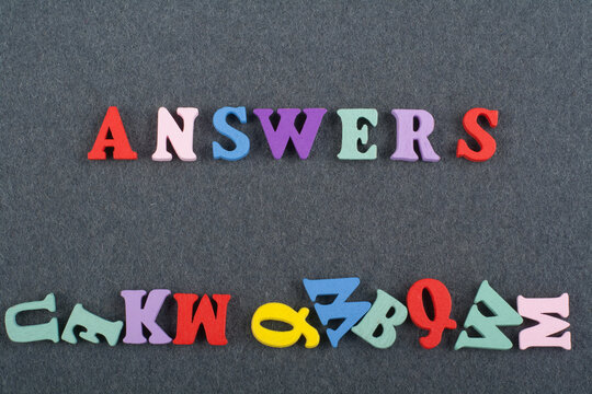 ANSWERS word on black board background composed from colorful abc alphabet block wooden letters, copy space for ad text. Learning english concept.