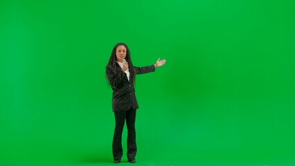 Young female reporter isolated on chroma key green screen background. Full shot african american...