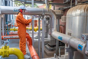 Maintenance technician at a heating plant,Petrochemical workers supervise the operation of gas and...