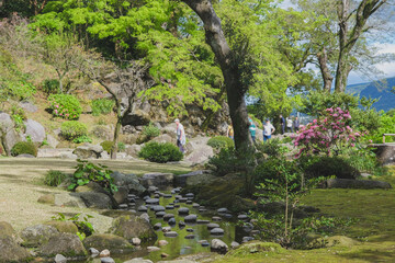Sengan-en Japanese garden with former Shimazu clan residence in Kagoshima Prefecture, Japan. Place of scenic landscape beauty with Shōko Shūseikan Meji Revolution Sakurajima lookout volcano view