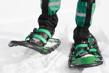 man walks in snowshoes on the snow
