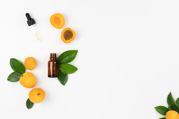 Natural Cosmetic Apricot Oil. Dropper lid with pipette and bottle on white background with fresh peach fruits and leaves. Top view, layout, place for text. - obrazy, fototapety, plakaty