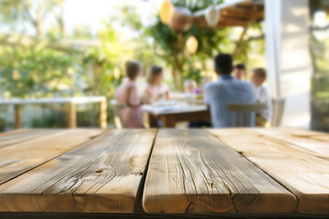A close up of an empty wooden table with people sitting at tables in the background, a family gathering around for dinner outside on a sunny day, trending photo of an outdoor cafe. - obrazy, fototapety, plakaty