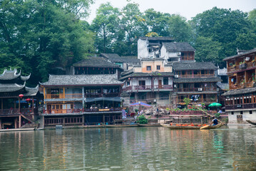 Fenghuang, China - September 30 2015: Boats sail in the river of Fenghuang village in China