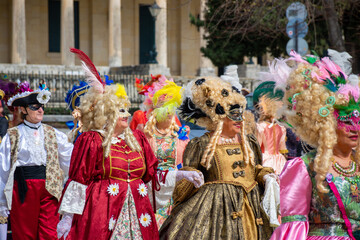 Colorful carnival masks and costumes at a traditional festival in Corfu,Greece - obrazy, fototapety, plakaty