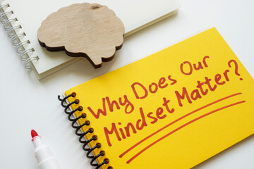 Brain model and notepad with a phrase why does our mindset matter.