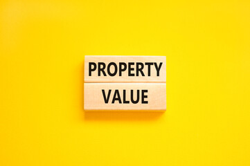 Property value symbol. Concept words Property value on beautiful wooden blocks. Beautiful yellow table yellow background. Business property value concept. Copy space.