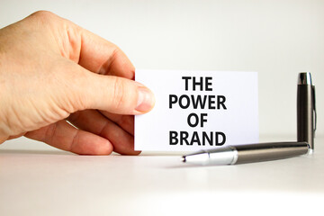 The power of brand symbol. Concept words The power of brand on beautiful white paper. Beautiful white background. Businessman hand. Business the power of brand concept. Copy space.