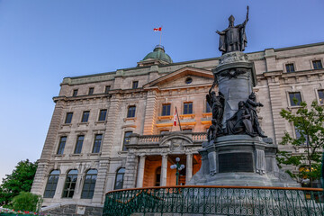 Historic post office building with the Statue of François Xavier de Montmorency Laval, first bishop of Quebec in Quebec City, Canada