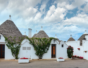 Trulli houses street in main touristic district of Alberobello beautiful old historic town, Apulia region, Southern Italy