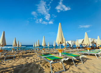 Morning paradise white sandy beach The Maldives of Salento with sunshades and sunbeds (Pescoluse,...